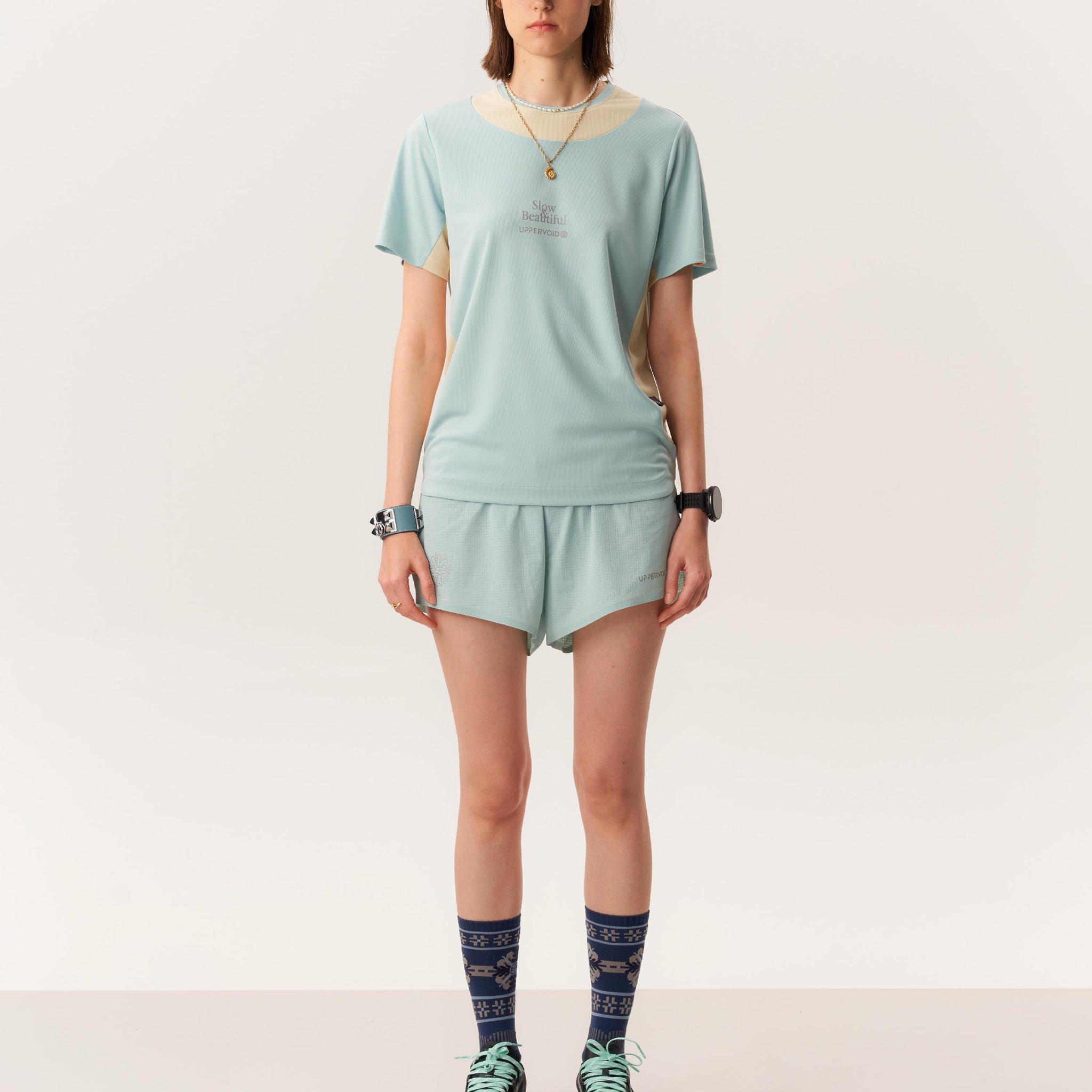 Model wearing TANITH moisture wicking short sleeve t-shirt and LAGO quick-dry seamless running shorts in studio lighting