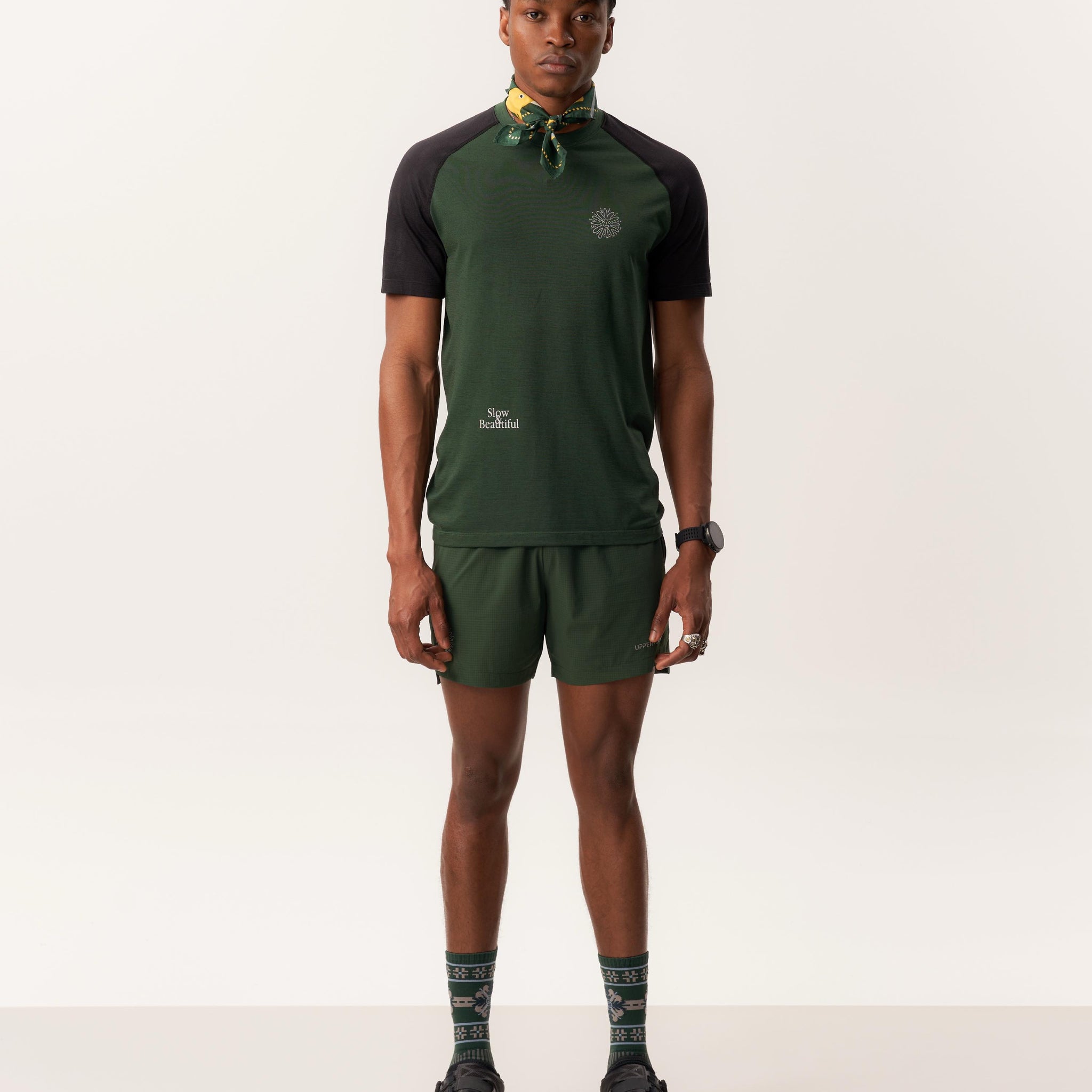 Model wearing MAAT merino t-shirt and CINTHIO breathable unlined shorts in neutral studio setting