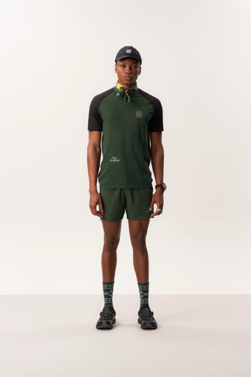 Model wearing MAAT merino t-shirt and CINTHIO breathable unlined shorts in neutral studio setting