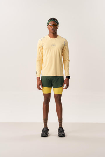 Model wearing TYET PRO moisture wicking long sleeve T-shirt and ENSIGN S lined running shorts in studio setup