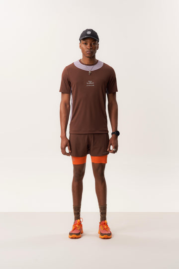 Model wearing TANITH athletic t shirt and ENSIGN S 5" trail running shorts in soft studio lighting