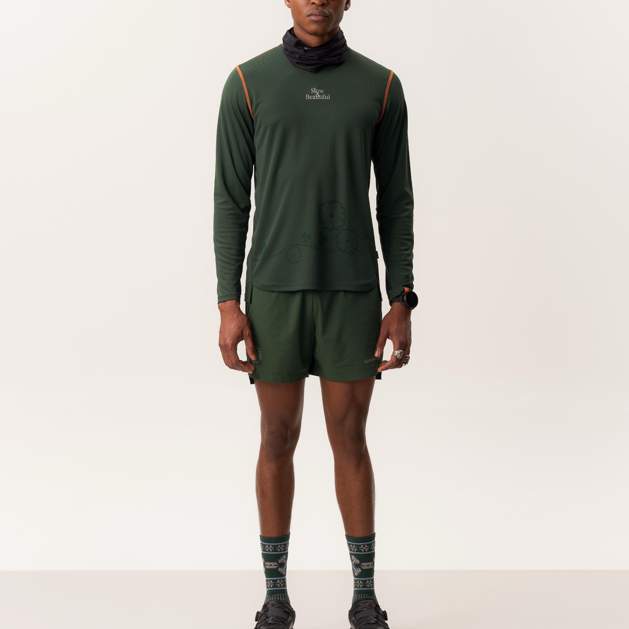 Model wearing TYET moisture-wicking long sleeve shirt with CINTHIO compression seamless shorts in studio lighting