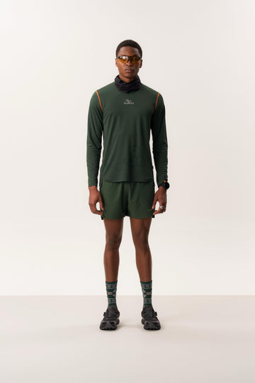 Model wearing TYET moisture-wicking long sleeve shirt with CINTHIO compression seamless shorts in studio lighting